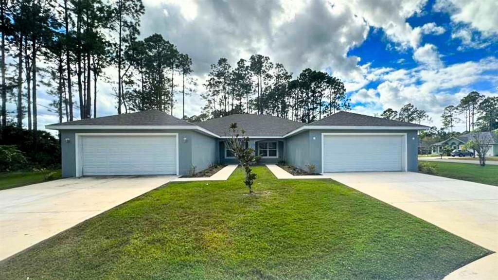 2 Ryapple Lane, Unit B Palm Coast, FL 32164 - Photo 2 of 13 a house view with a garden space