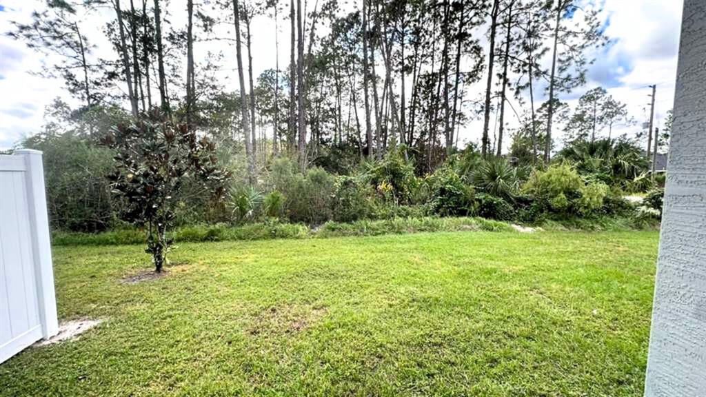 2 Ryapple Lane, Unit B Palm Coast, FL 32164 - Photo 3 of 13 a view of yard with small trees