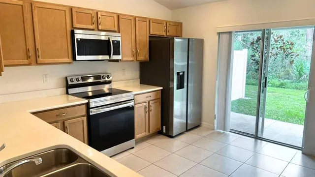 a kitchen with a refrigerator stove and microwave