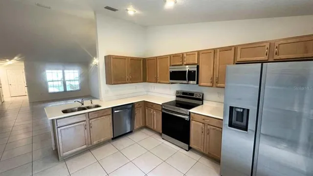a kitchen with a sink stove and refrigerator