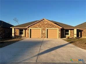 1102 Zora Drive, Unit A & B Temple, TX 76504 - Photo 1 of 30 a front view of a house with a yard and garage