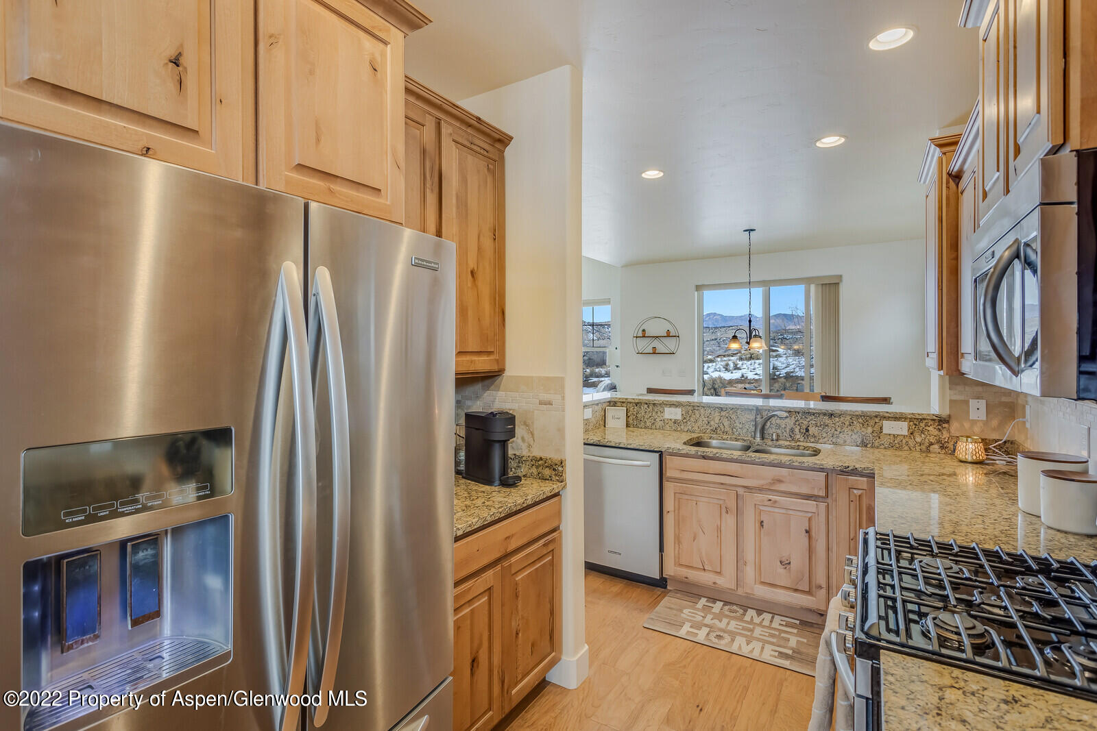 1413 Munro Avenue Rifle, CO 81650 - Photo 3 of 22 a kitchen with stainless steel appliances a refrigerator sink and stove