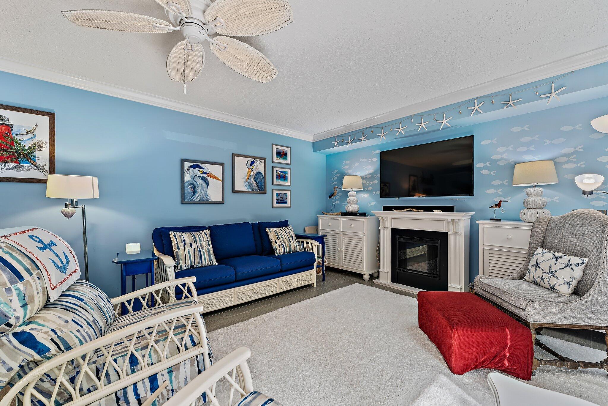 2403 24th Court Jupiter, FL 33477 - Photo 15 of 29 a living room with furniture or flat screen tv and a fireplace