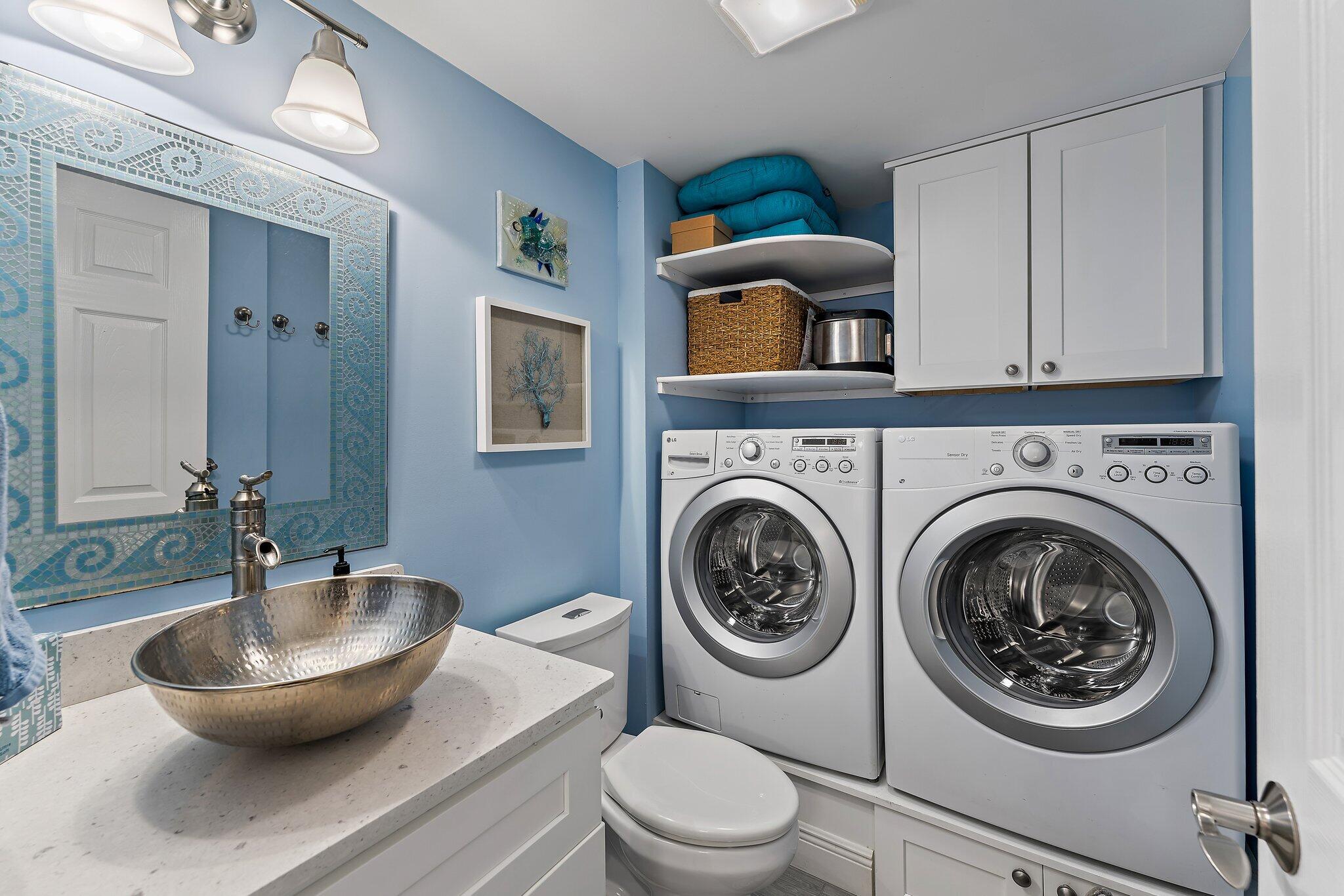 2403 24th Court Jupiter, FL 33477 - Photo 17 of 29 a bathroom with a toilet a sink and mirror