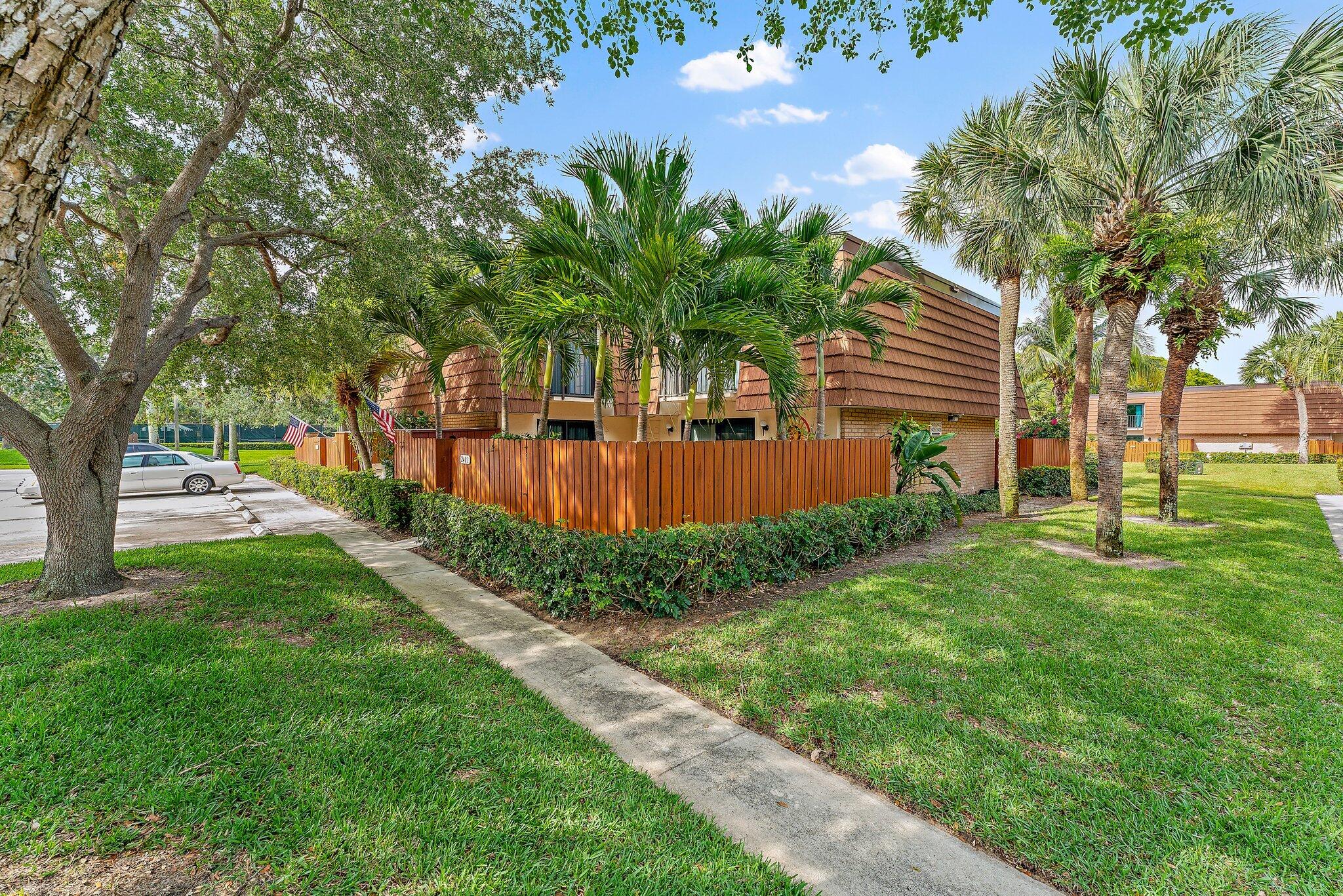 2403 24th Court Jupiter, FL 33477 - Photo 2 of 29 a view of a backyard with large trees