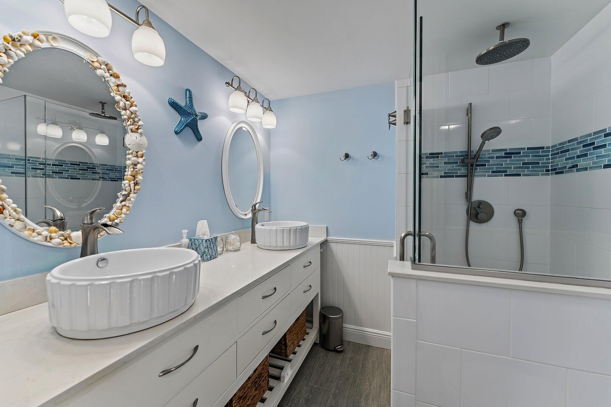 2403 24th Court Jupiter, FL 33477 - Photo 22 of 29 a bathroom with a double vanity sink mirror and shower