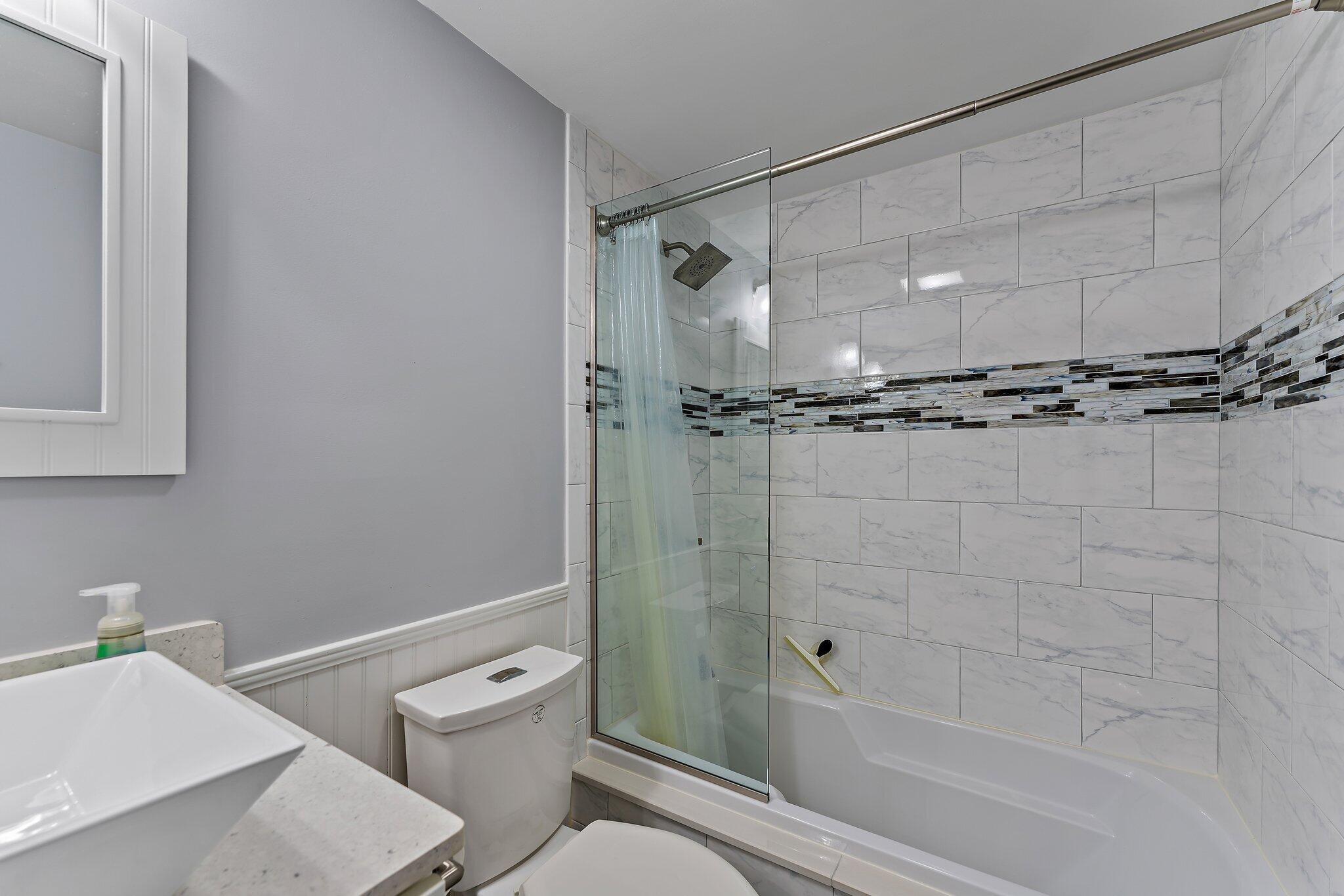 2403 24th Court Jupiter, FL 33477 - Photo 28 of 29 a bathroom with a shower and a toilet