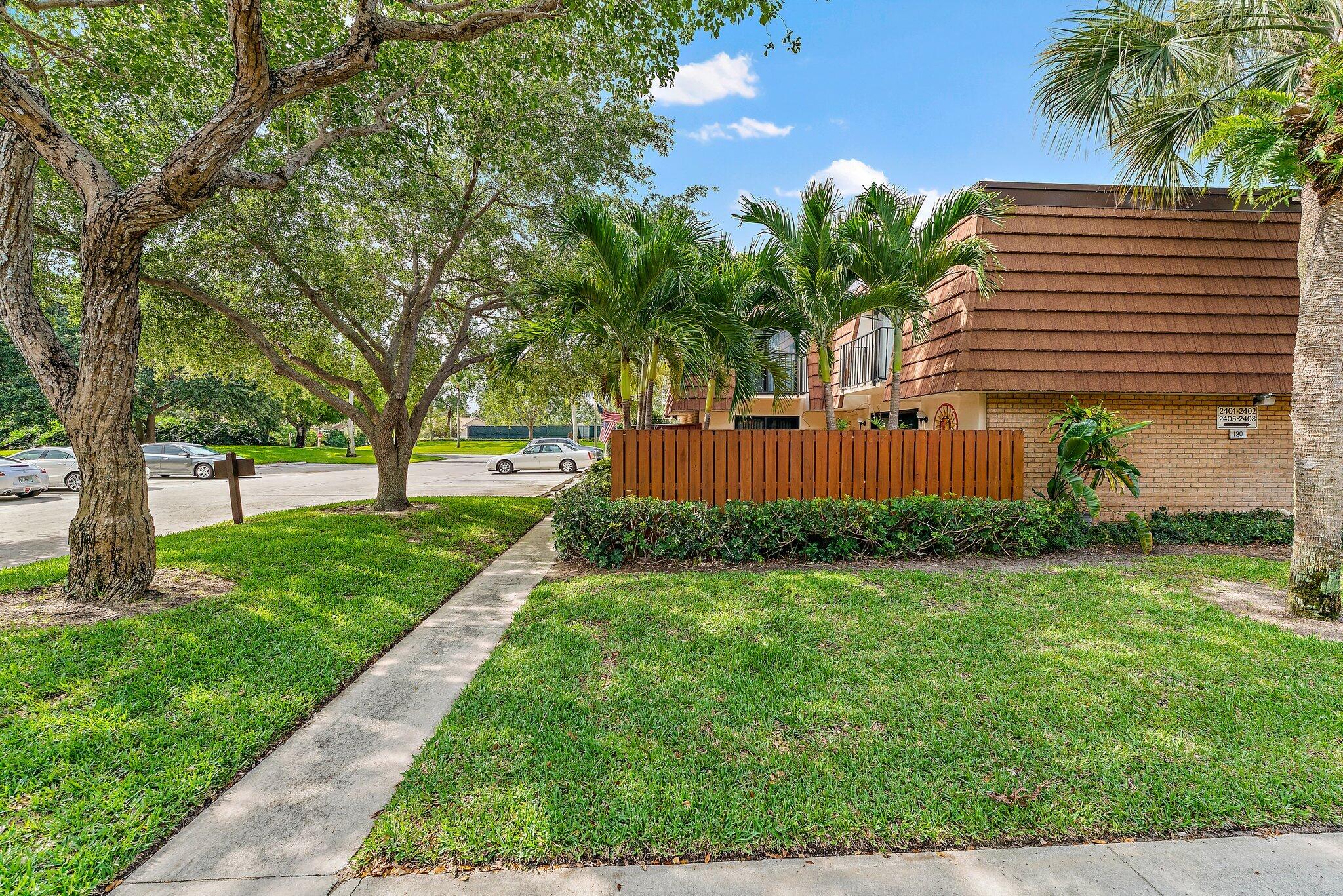 2403 24th Court Jupiter, FL 33477 - Photo 3 of 29 a view of a backyard with a garden
