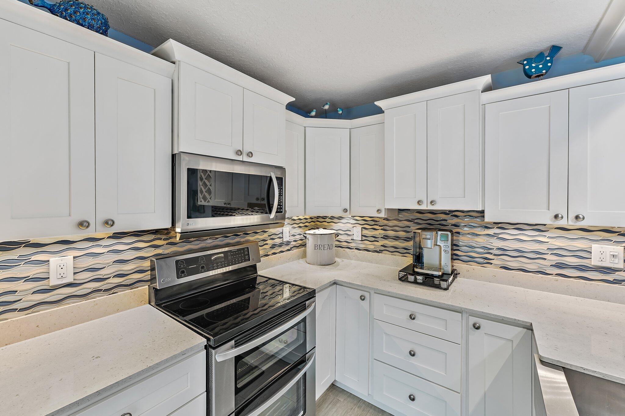 2403 24th Court Jupiter, FL 33477 - Photo 8 of 29 a kitchen with appliances a sink and cabinets