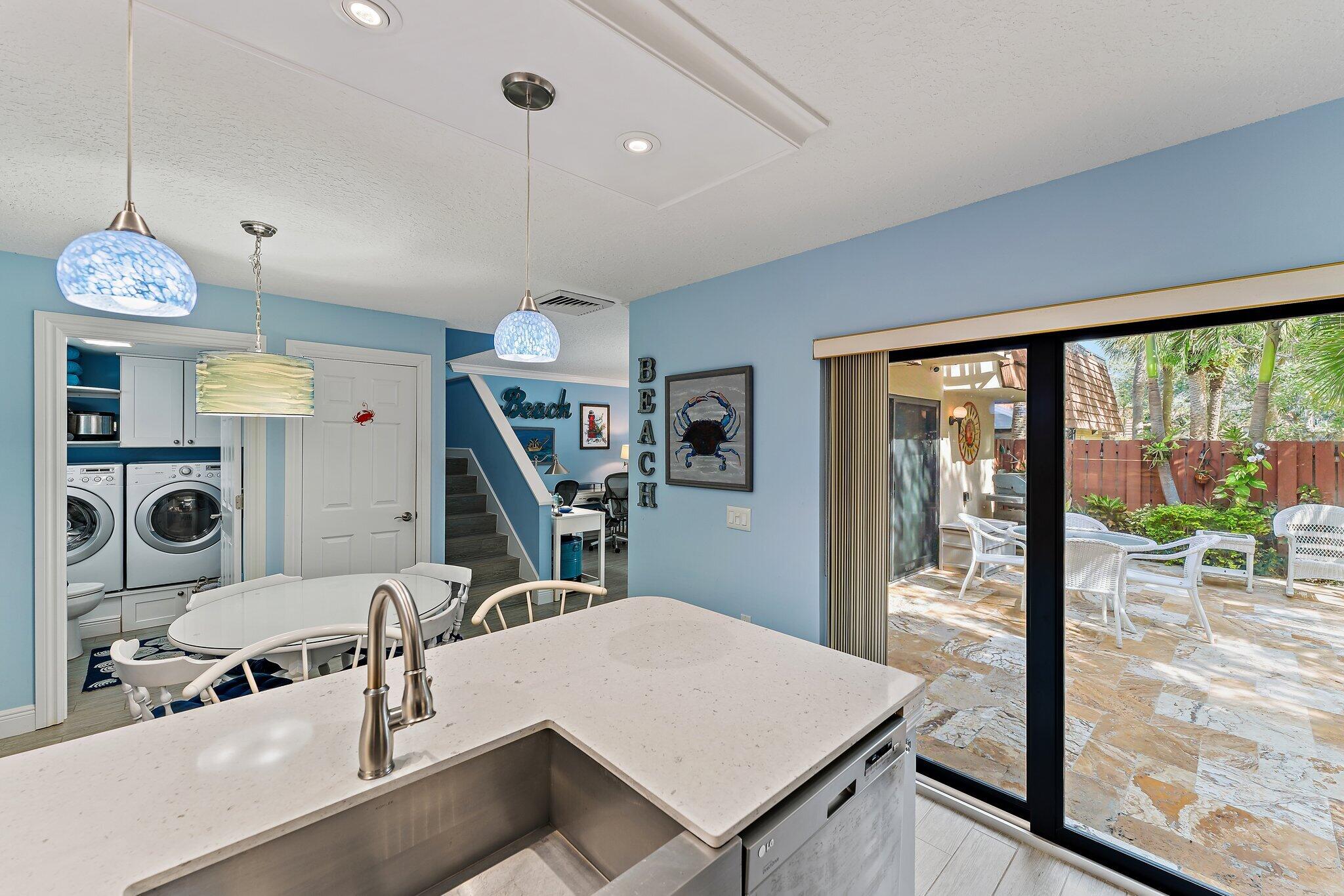 2403 24th Court Jupiter, FL 33477 - Photo 9 of 29 a view of a dining room with furniture water view and a chandelier