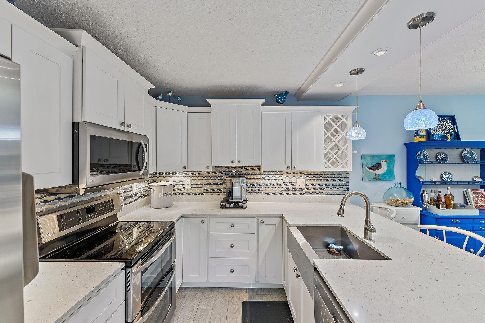 2403 24th Court Jupiter, FL 33477 - Photo 10 of 29 a kitchen that has a stove and a microwave