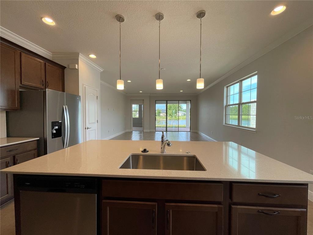 3434 Sagebrush Street Harmony, FL 34773 - Photo 4 of 21 a kitchen with a sink a center island and wooden floor