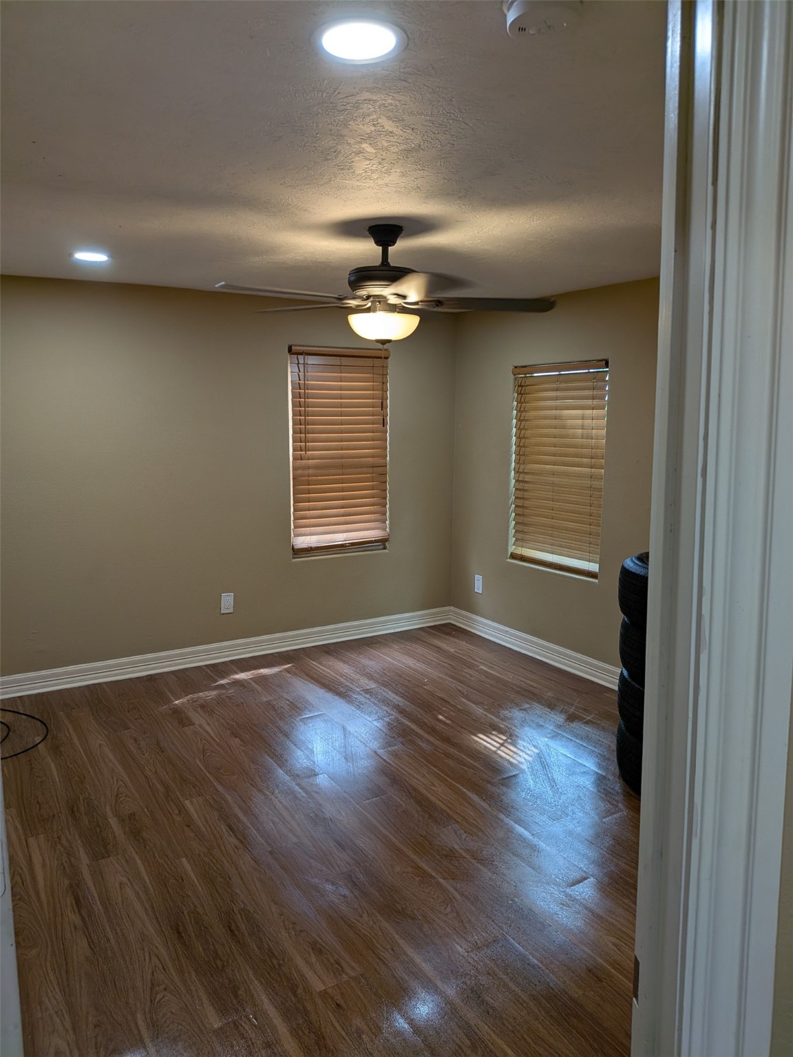 807 Ruth Street Baytown, TX 77520 - Photo 31 of 36 an empty room with wooden floor chandelier and windows