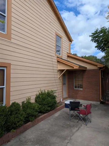 a backyard of a house with table and chairs