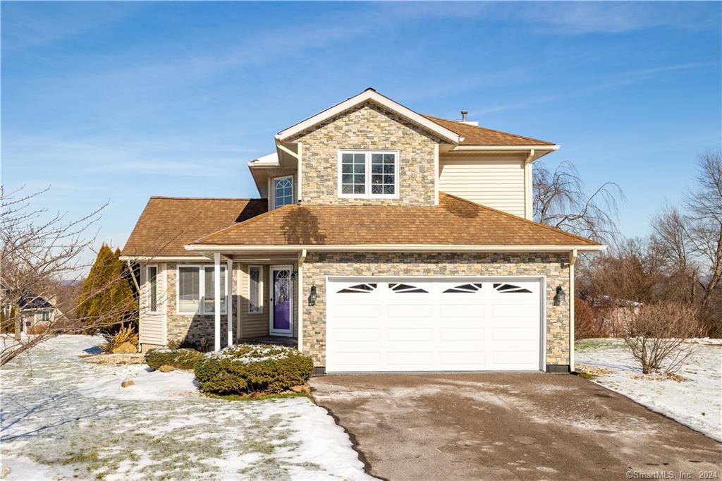 a front view of a house with a yard and garage