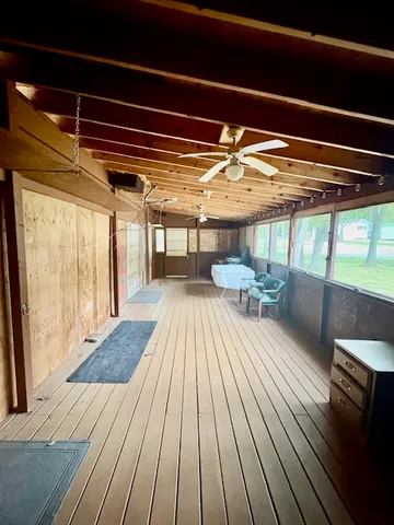 a view of a balcony with wooden floor