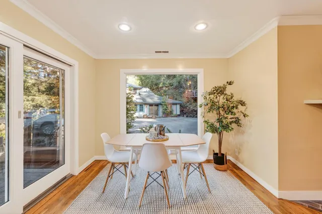 a dining room with furniture and a window