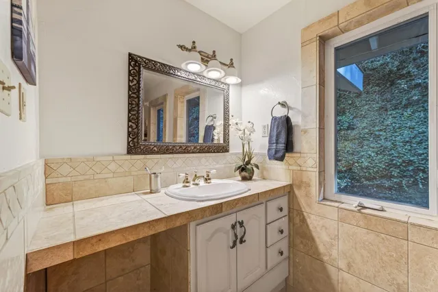 a bathroom with a sink double vanity and a mirror