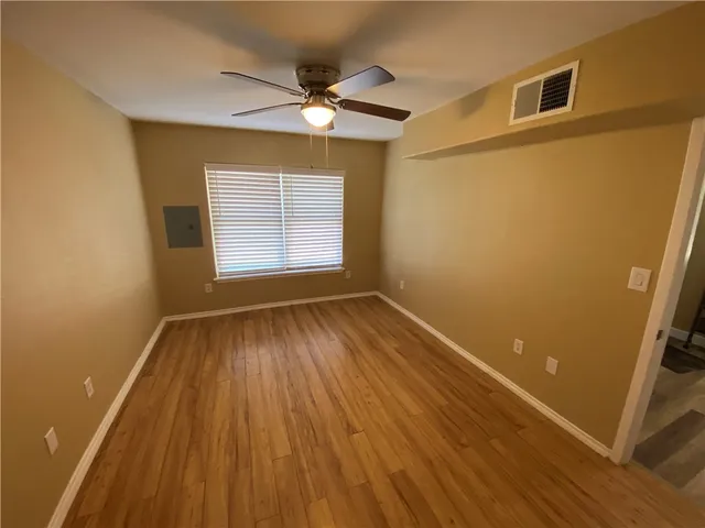a view of wooden floor and a chandelier in a room
