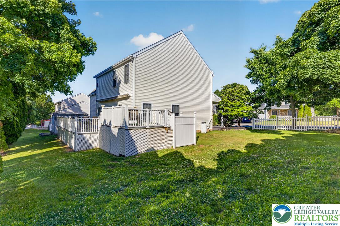 1702 Red Bud Road Quakertown, PA 18951 - Photo 68 of 68 A pristine backyard features a spacious wooden deck, perfect for outdoor enjoyment and relaxation.