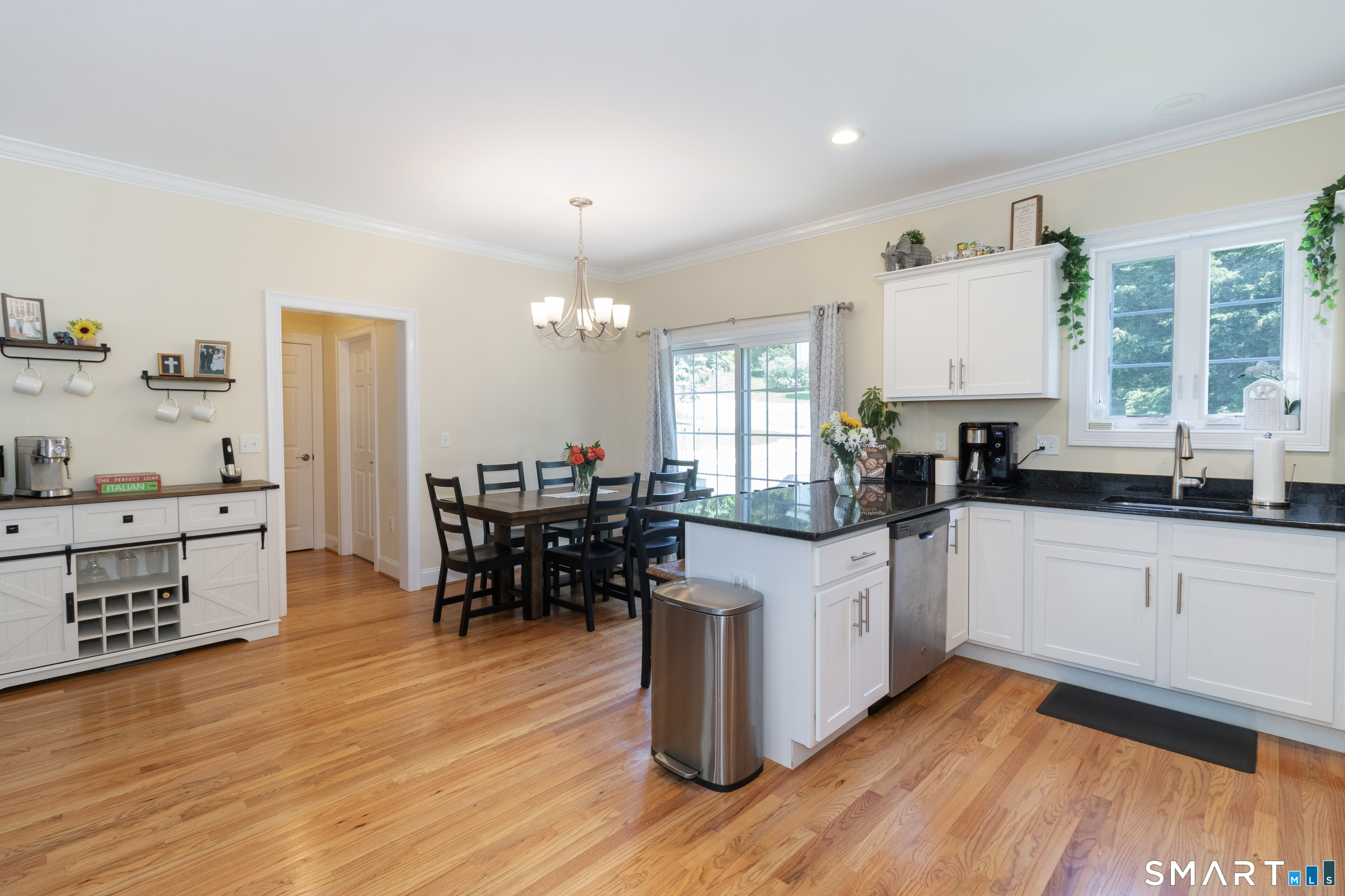 656 Bartholomew Road, Unit 656 Middletown, CT 06457 - Photo 11 of 27 a kitchen with stainless steel appliances kitchen island wooden floors and white cabinets