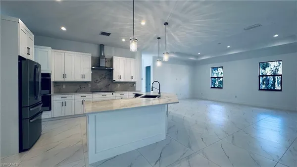 a large kitchen with a large counter top appliances and cabinets