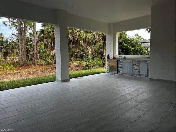a view of backyard with large trees and wooden floor