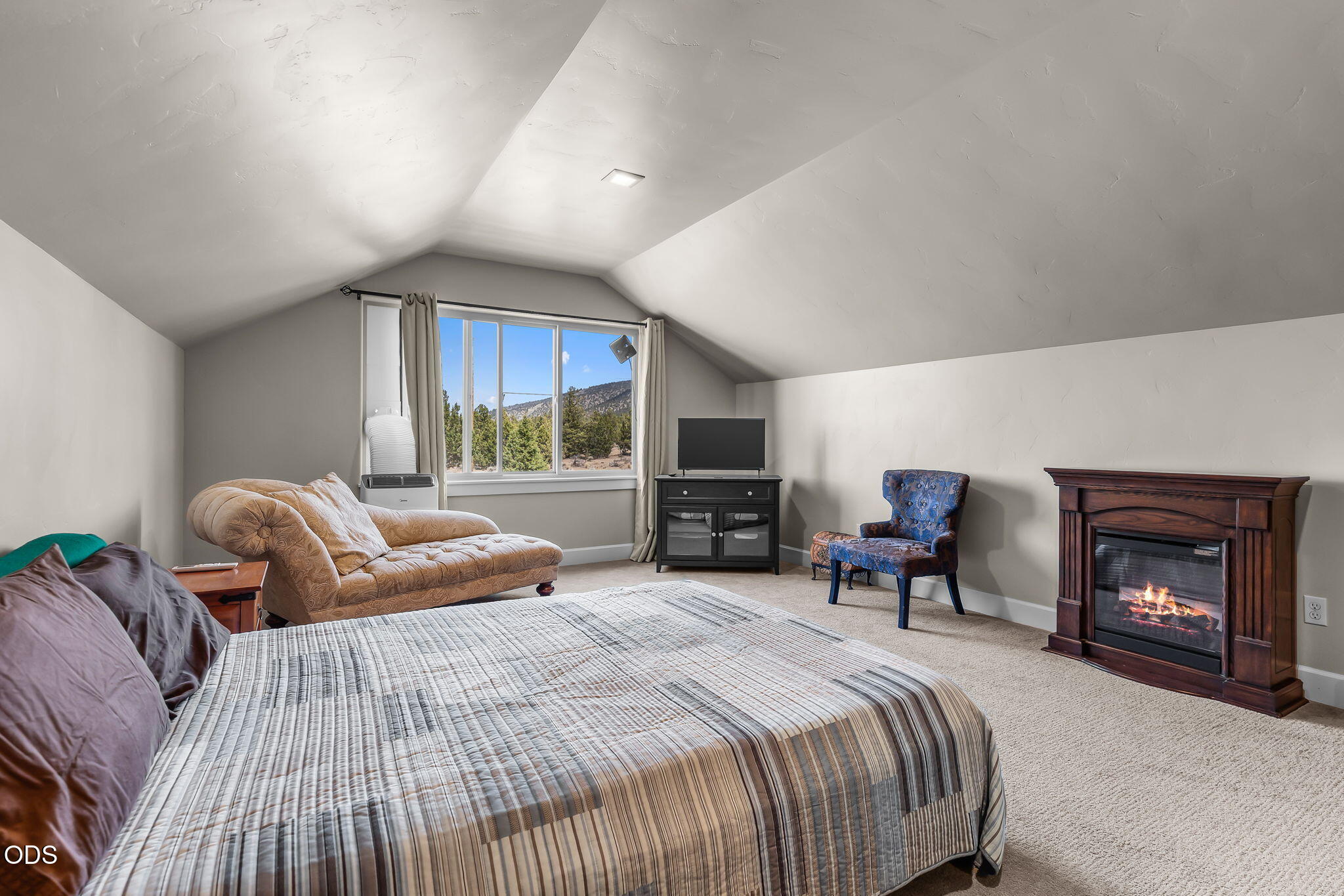 13601 Southwest Harrison Way Powell Butte, OR 97753 - Photo 42 of 81 a bedroom with a bed and a fireplace