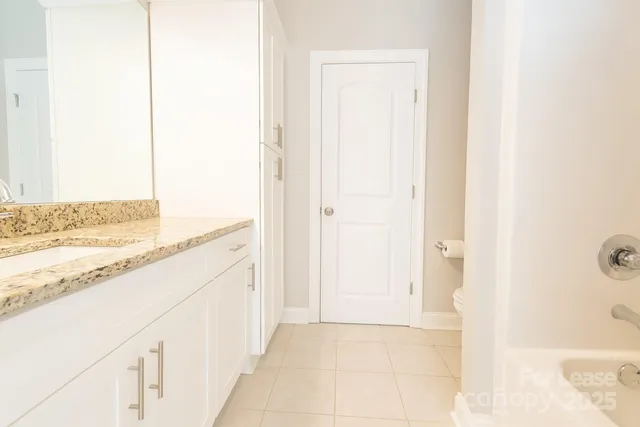 a view of a kitchen with kitchen island and hallway