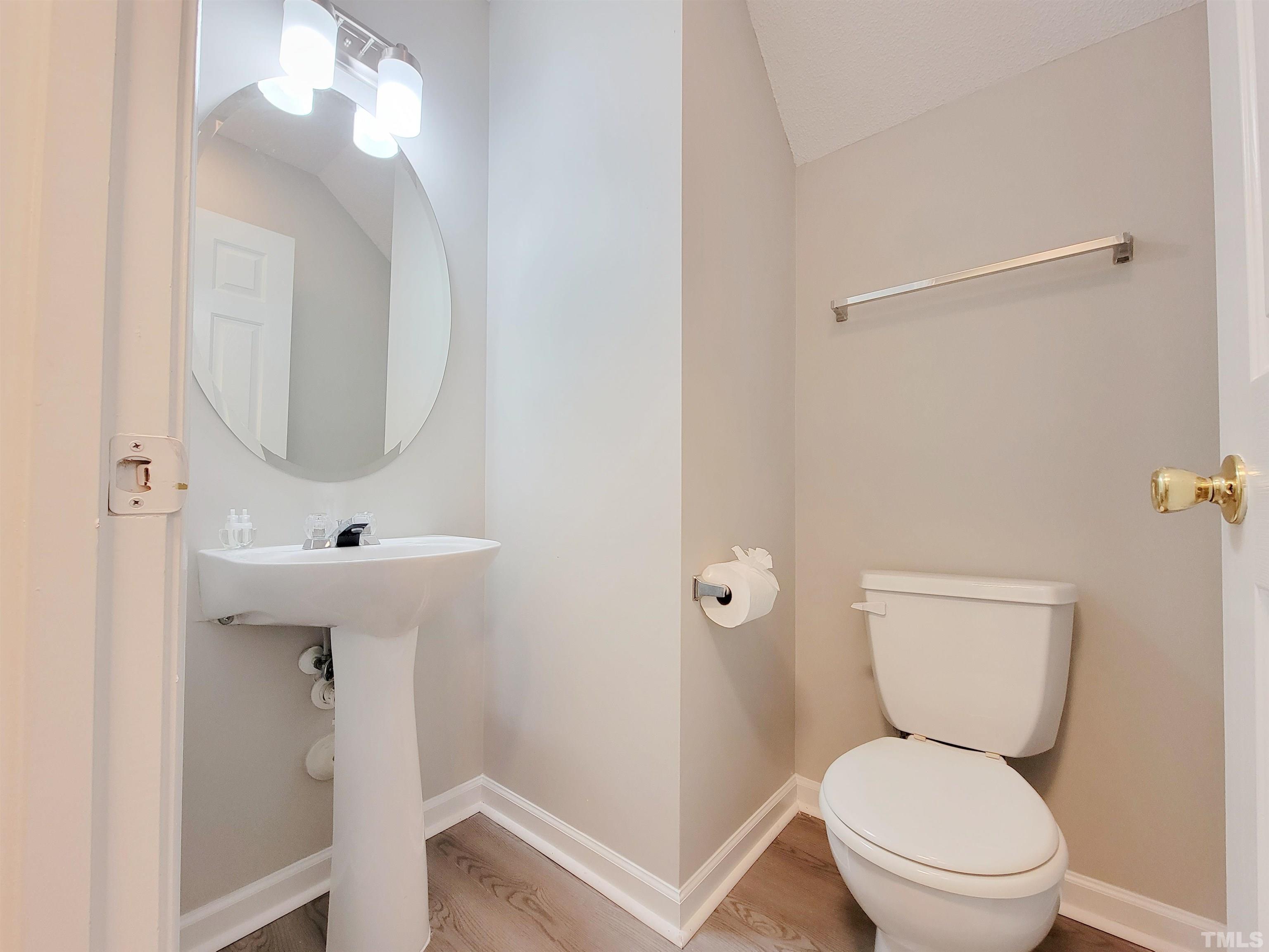 3240 Marcony Way Raleigh, NC 27610 - Photo 14 of 31 a bathroom with a toilet sink and mirror