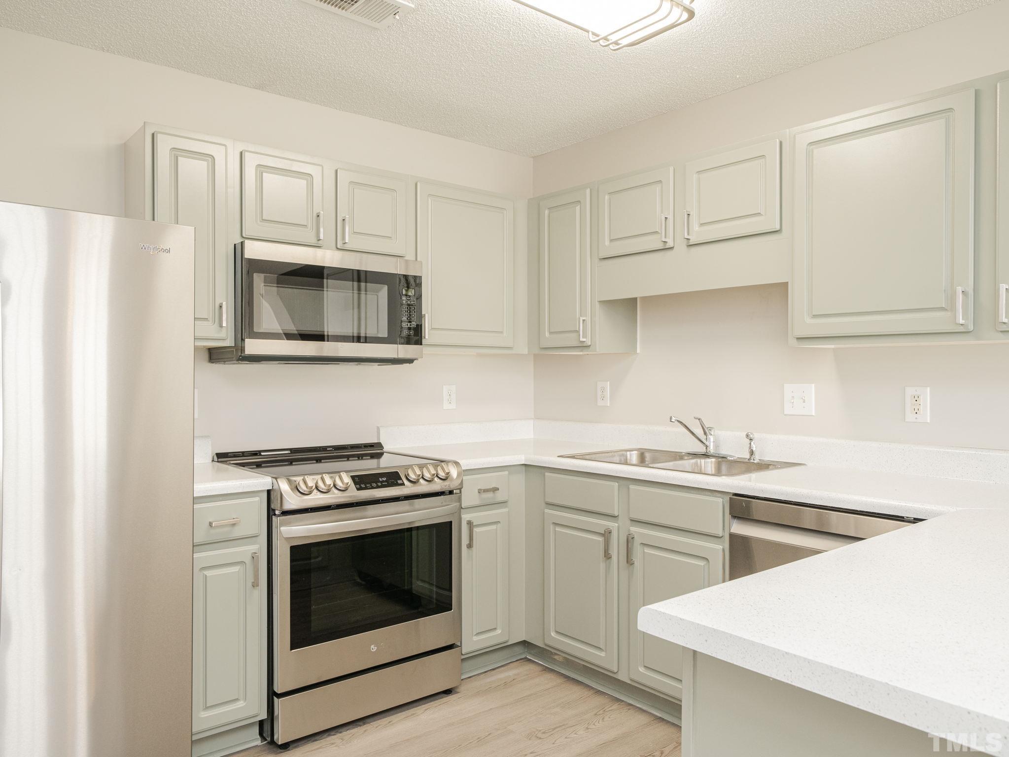 3240 Marcony Way Raleigh, NC 27610 - Photo 15 of 31 a kitchen with cabinets stainless steel appliances and sink
