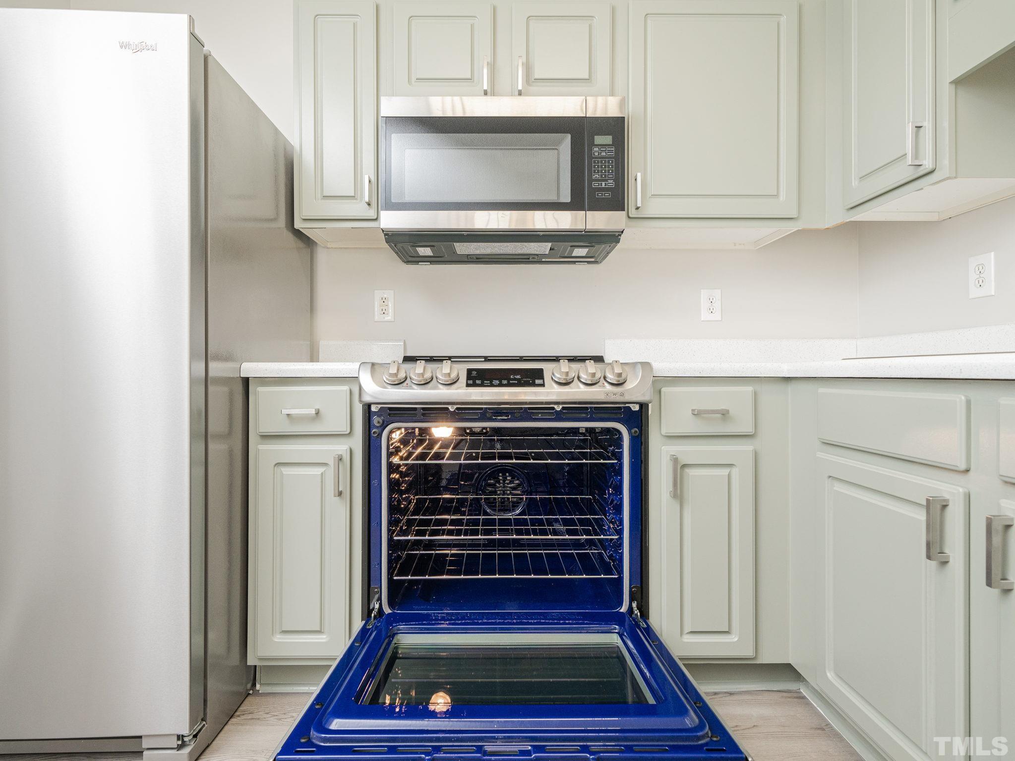 3240 Marcony Way Raleigh, NC 27610 - Photo 19 of 31 a stove top oven sitting inside of a kitchen