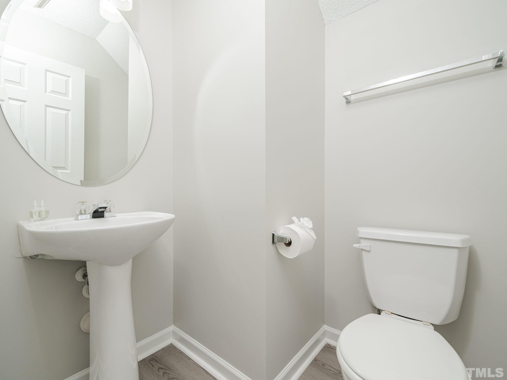 3240 Marcony Way Raleigh, NC 27610 - Photo 22 of 31 a bathroom with a toilet sink and mirror