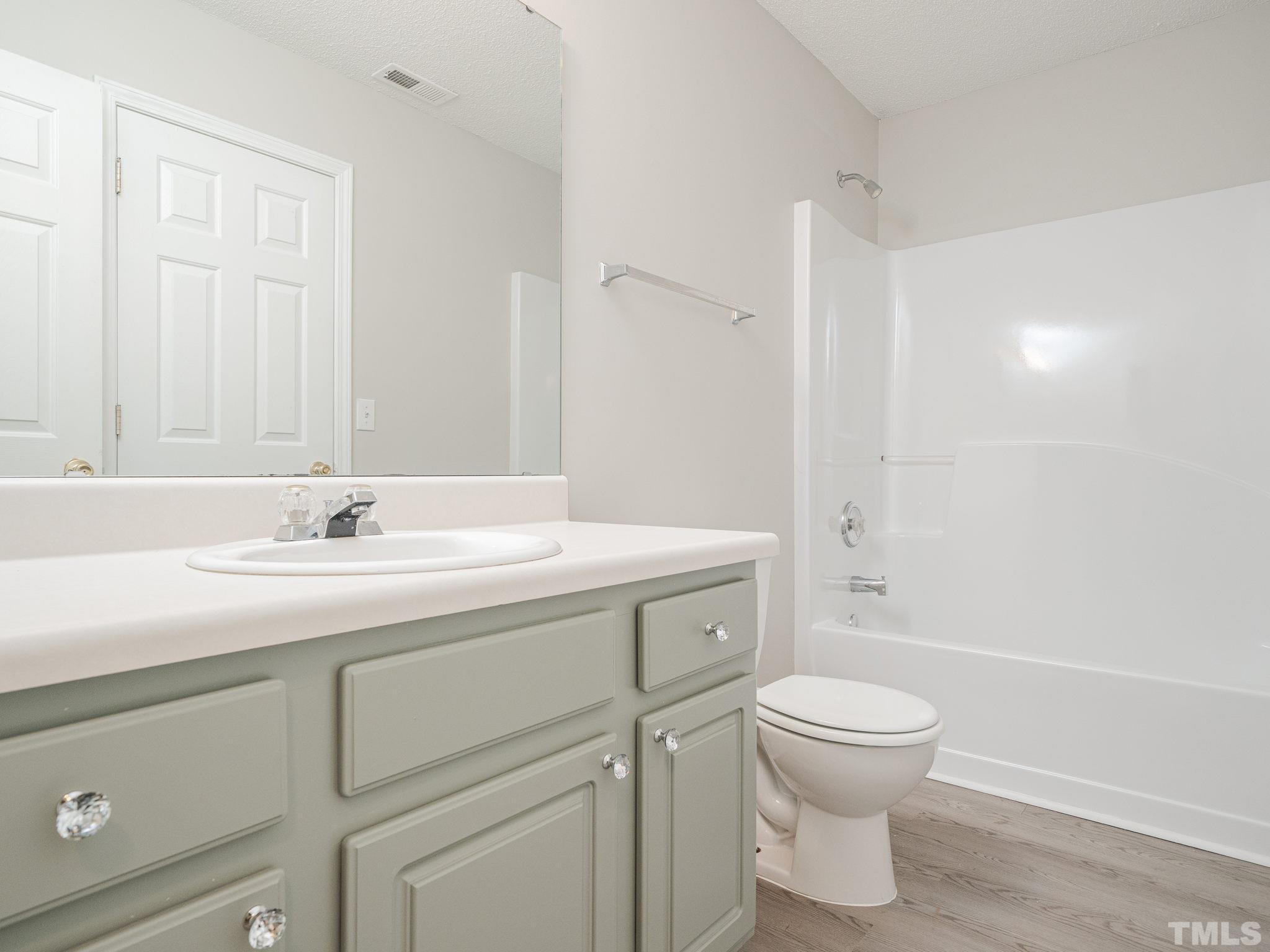 3240 Marcony Way Raleigh, NC 27610 - Photo 23 of 31 a bathroom with a sink toilet vanity and shower
