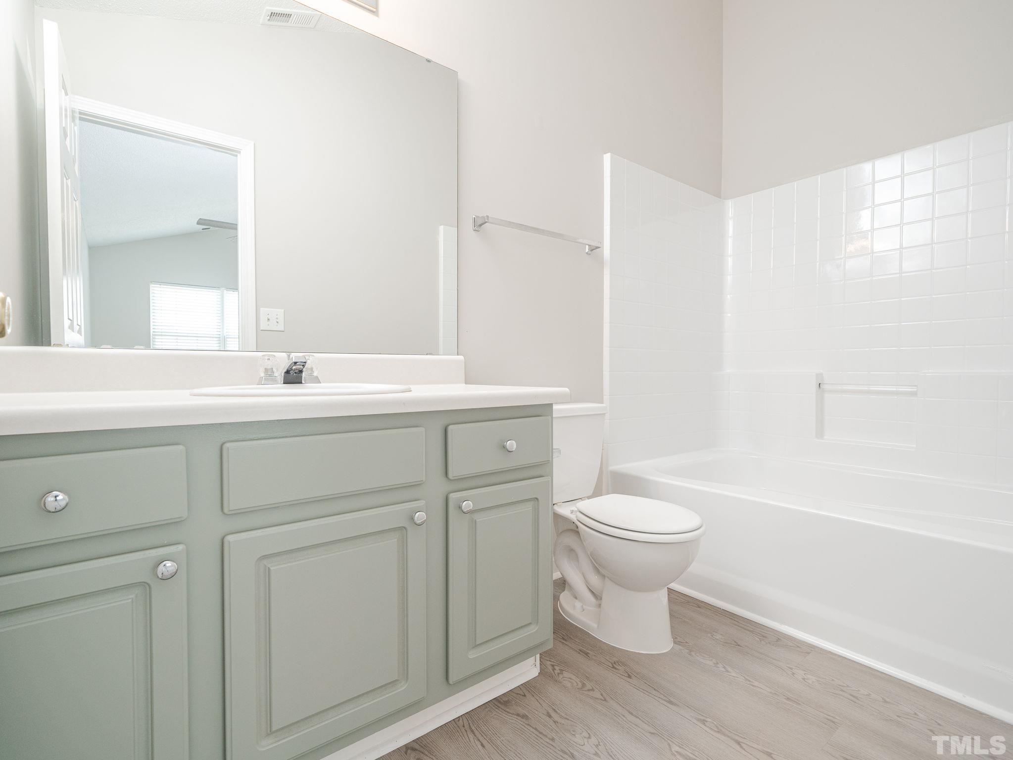 3240 Marcony Way Raleigh, NC 27610 - Photo 27 of 31 a bathroom with a toilet sink and mirror