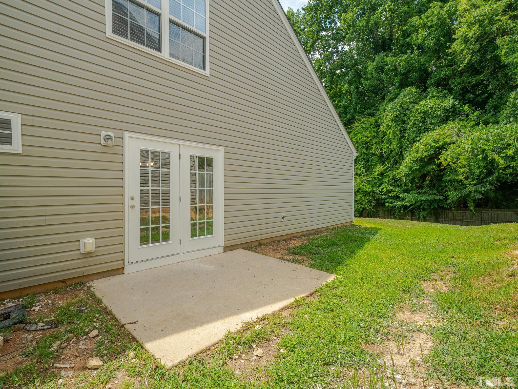 3240 Marcony Way Raleigh, NC 27610 - Photo 30 of 31 a view of a backyard with plants and large tree