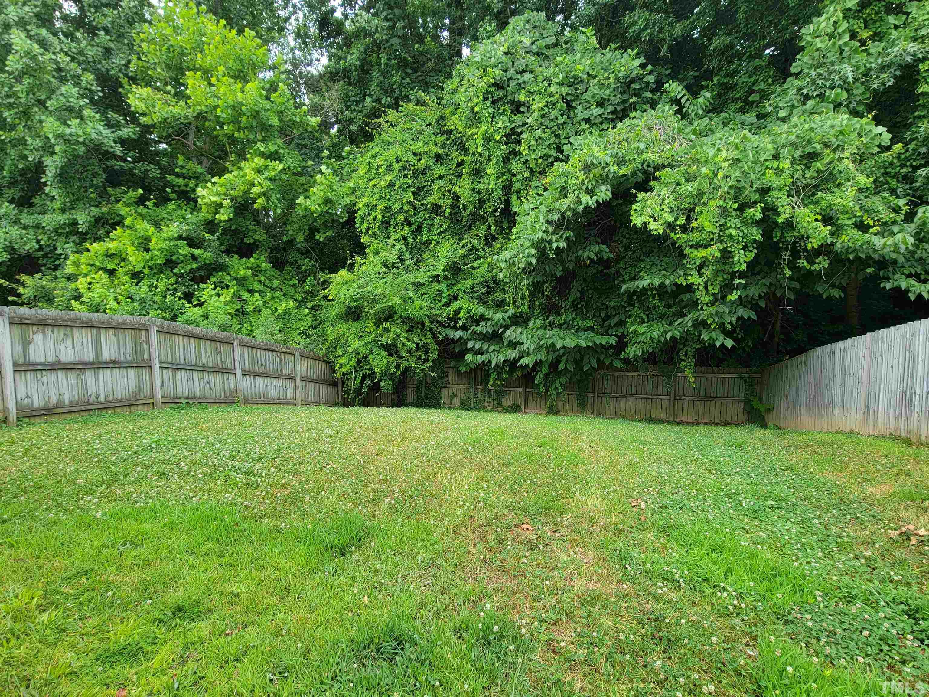 3240 Marcony Way Raleigh, NC 27610 - Photo 4 of 31 a view of a backyard with a wooden fence