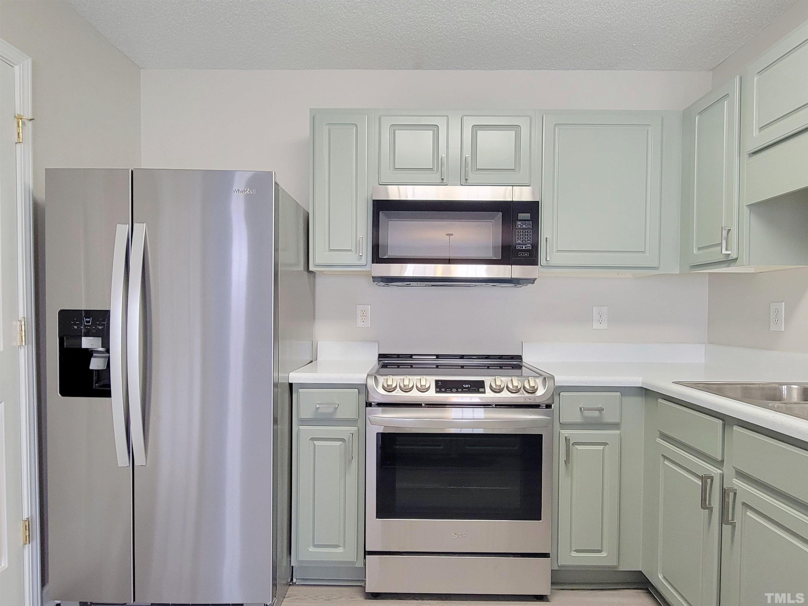 3240 Marcony Way Raleigh, NC 27610 - Photo 6 of 31 a kitchen with cabinets stainless steel appliances and wooden cabinets