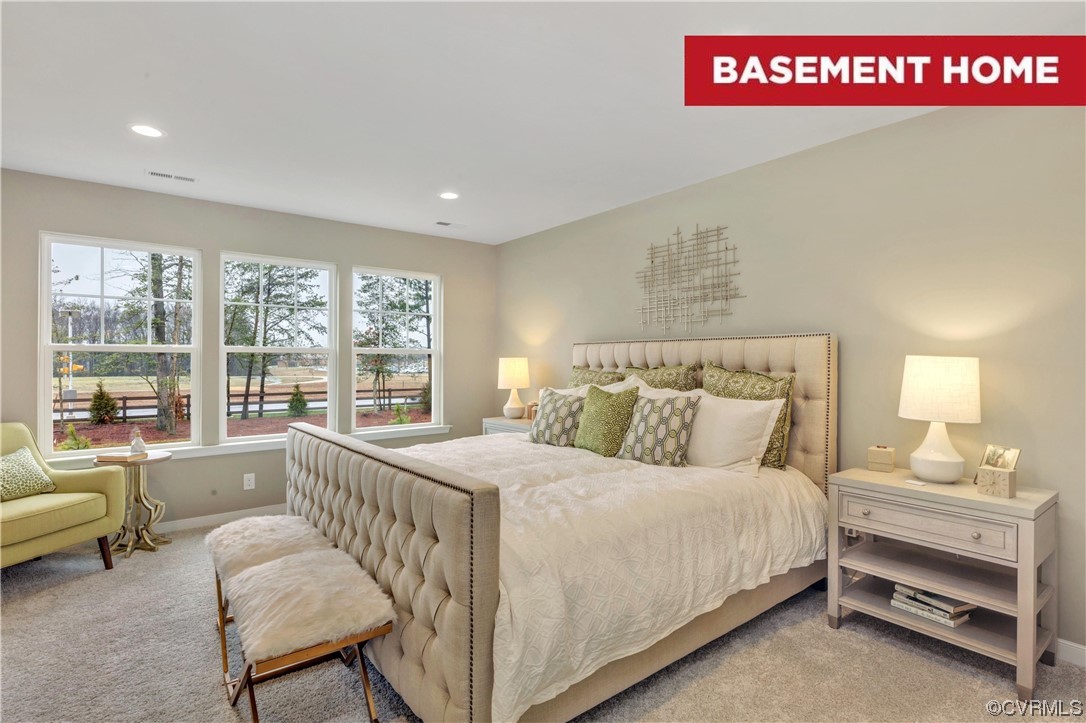 a bedroom with a bed and a couch next to a window