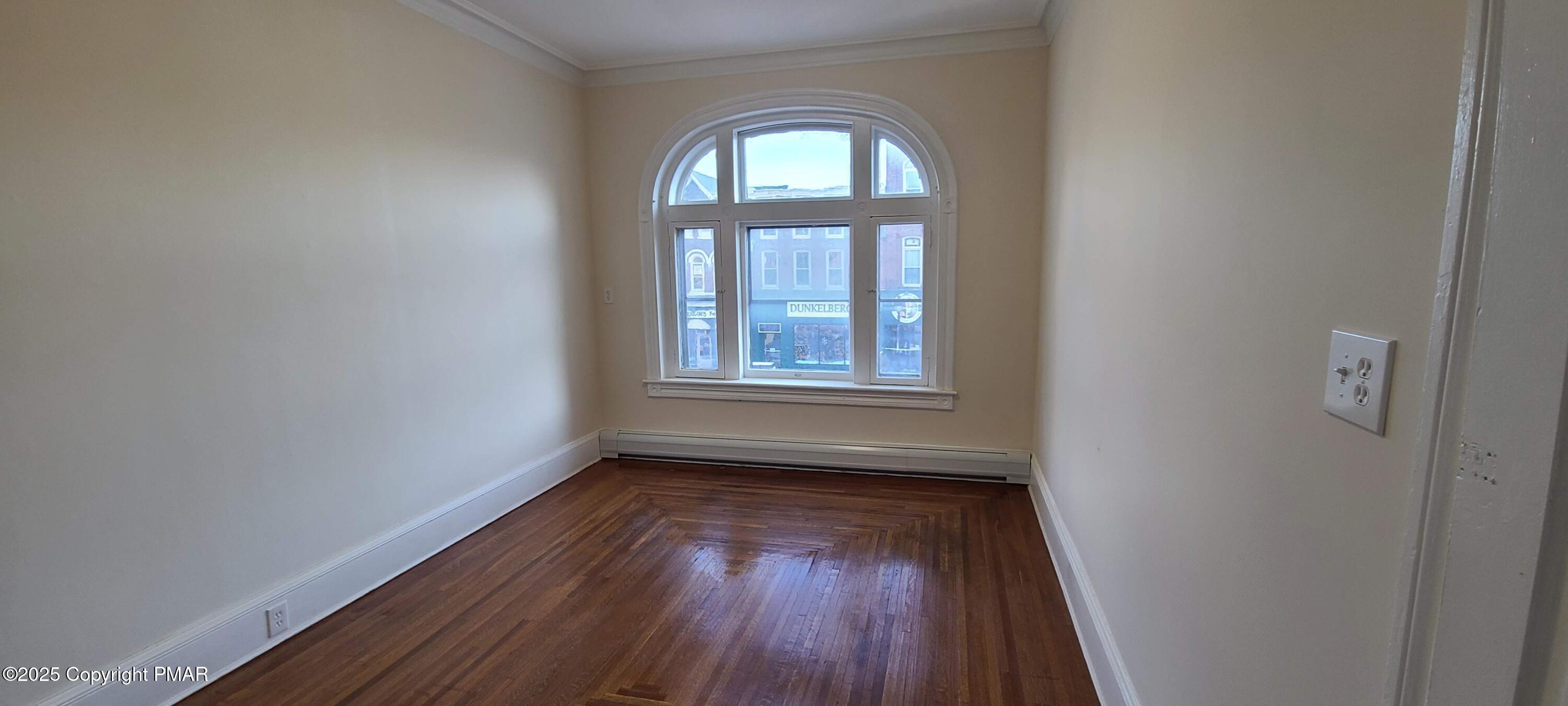 584 Main Street, Unit 1 Stroudsburg, PA 18360 - Photo 13 of 17 wooden floor in an empty room with a window