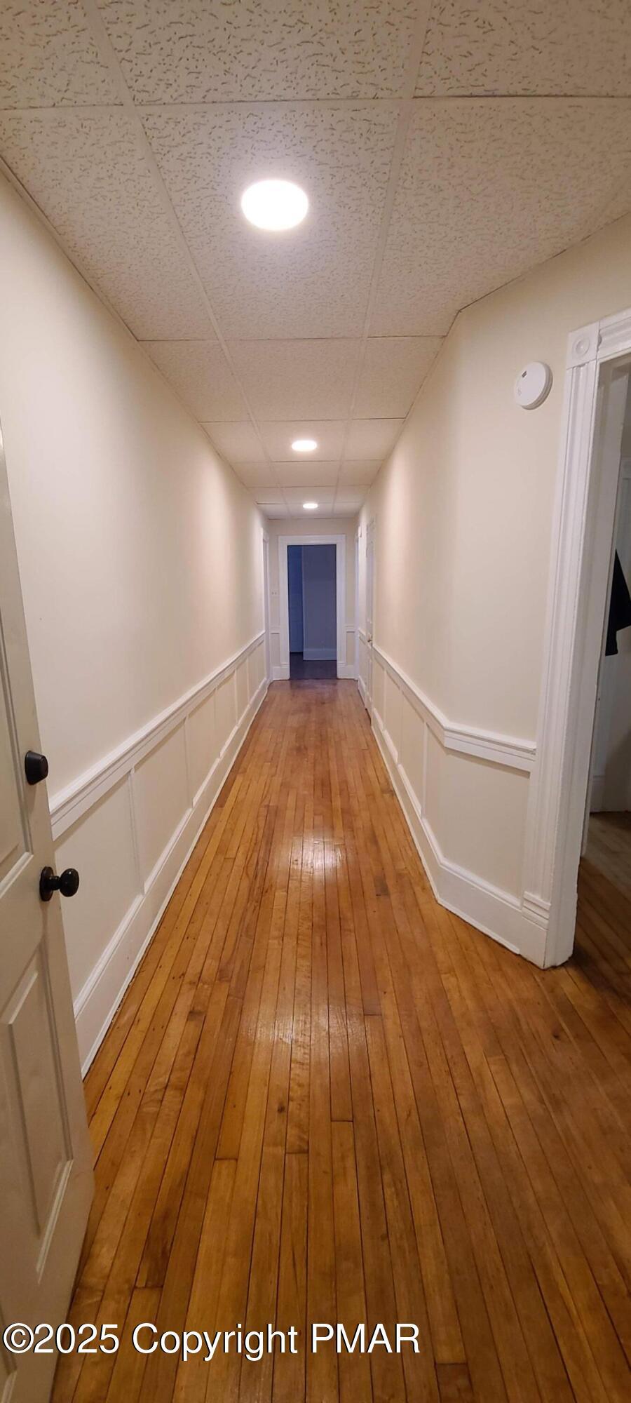584 Main Street, Unit 1 Stroudsburg, PA 18360 - Photo 5 of 17 a view of a big room with wooden floor and windows