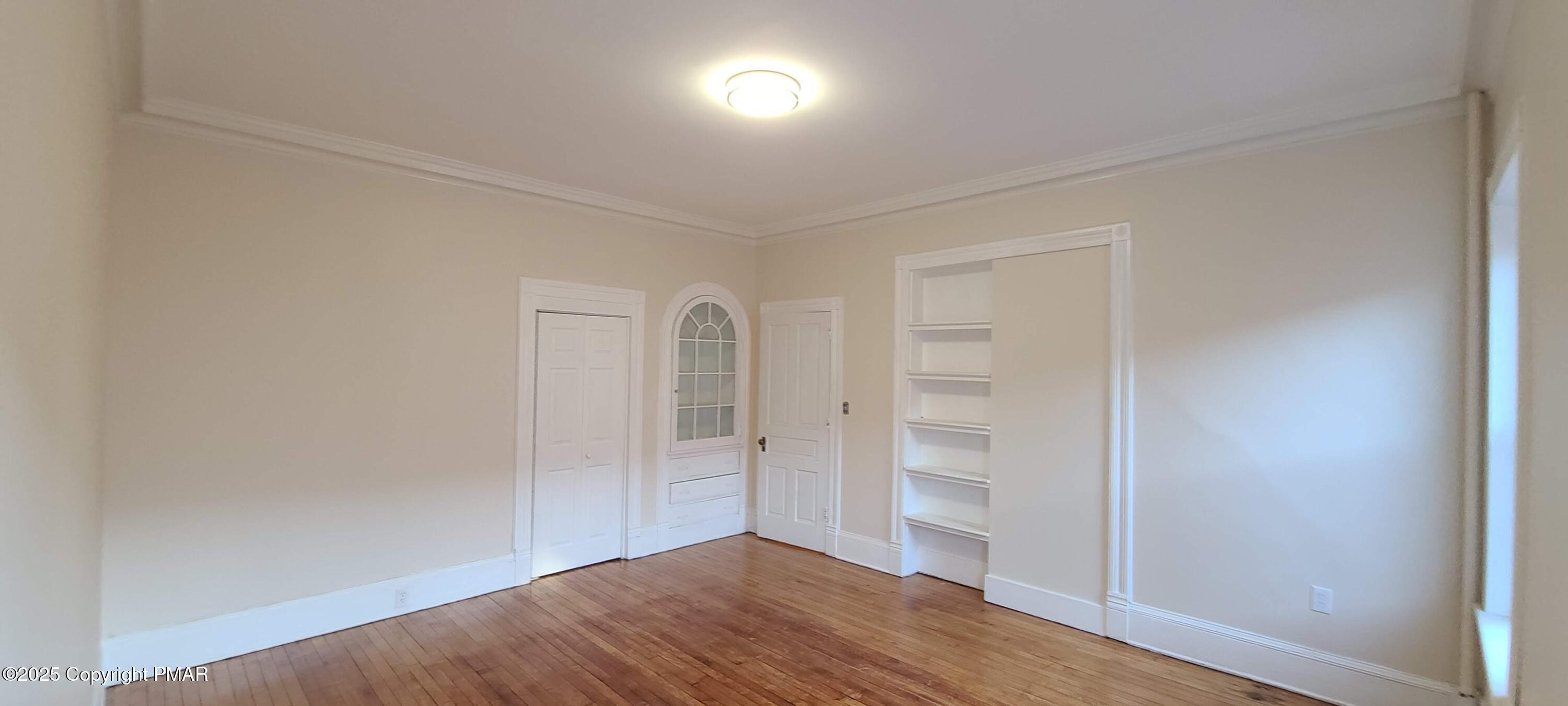 584 Main Street, Unit 1 Stroudsburg, PA 18360 - Photo 8 of 17 wooden floor in an empty room with a window
