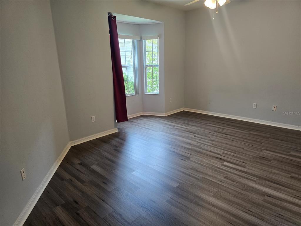 7976 48 Way Gainesville, FL 32653 - Photo 9 of 26 an empty room with wooden floor and windows