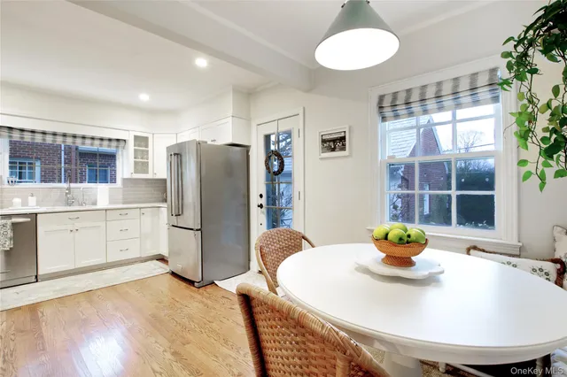 a kitchen with stainless steel appliances granite countertop a sink and a refrigerator