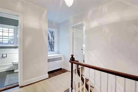a view of a hallway with windows and stairs
