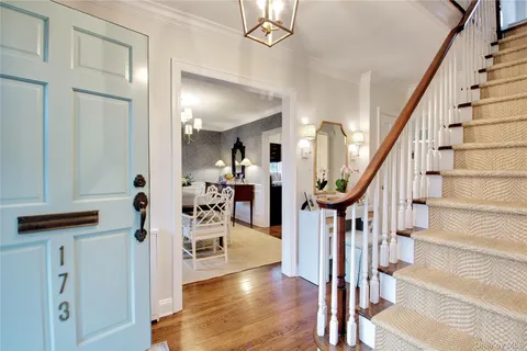 a view of entryway and hall with wooden floor