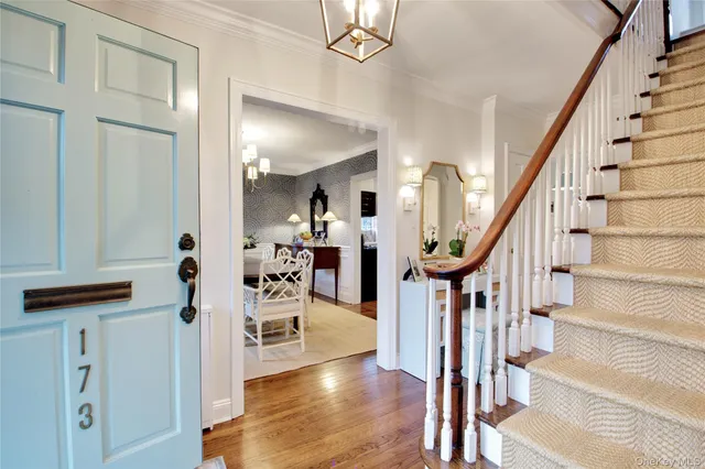 a view of entryway and hall with wooden floor
