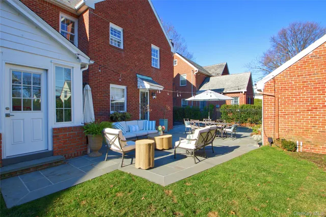 a building outdoor space with patio furniture and potted plants
