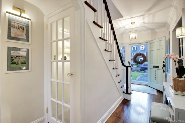 a view of an entryway with wooden floor and windows
