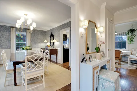 a view of a dining room with furniture a chandelier and wooden floor